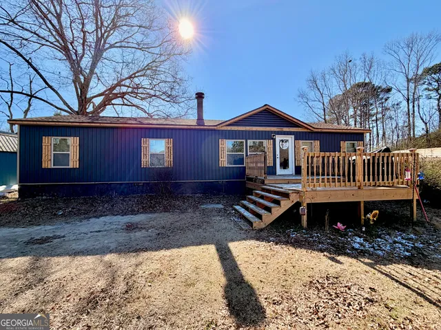 a front view of a house with garden and deck