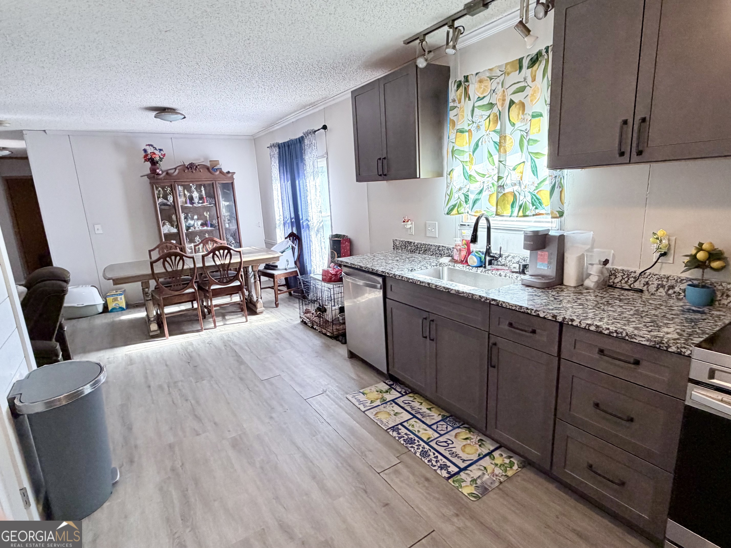 5448 Blanton Mill Road Williamson, GA 30292 - Photo 12 of 50 a kitchen with granite countertop a sink dishwasher stove and cabinets
