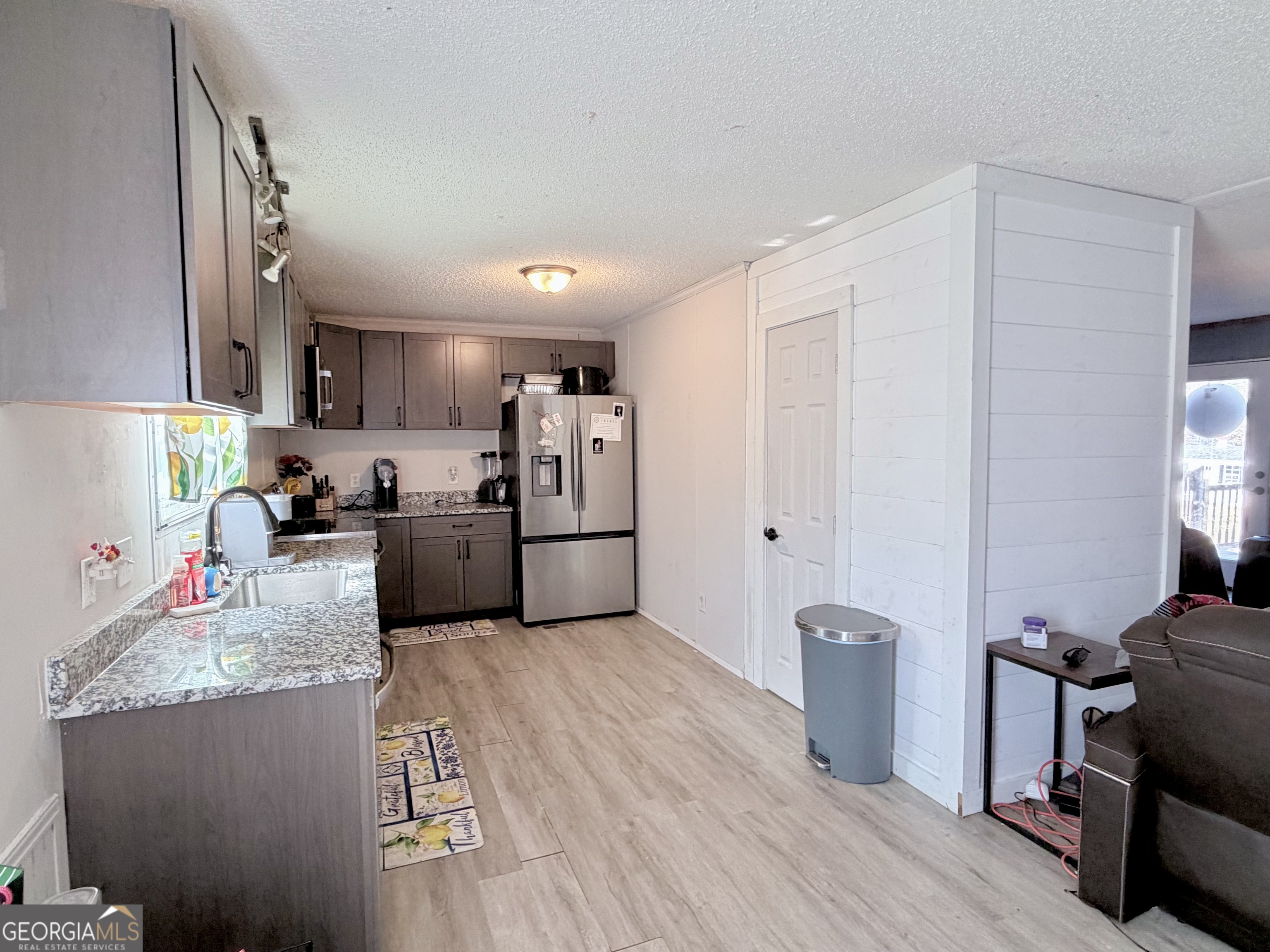 5448 Blanton Mill Road Williamson, GA 30292 - Photo 13 of 50 a kitchen with stainless steel appliances granite countertop a refrigerator sink and cabinets