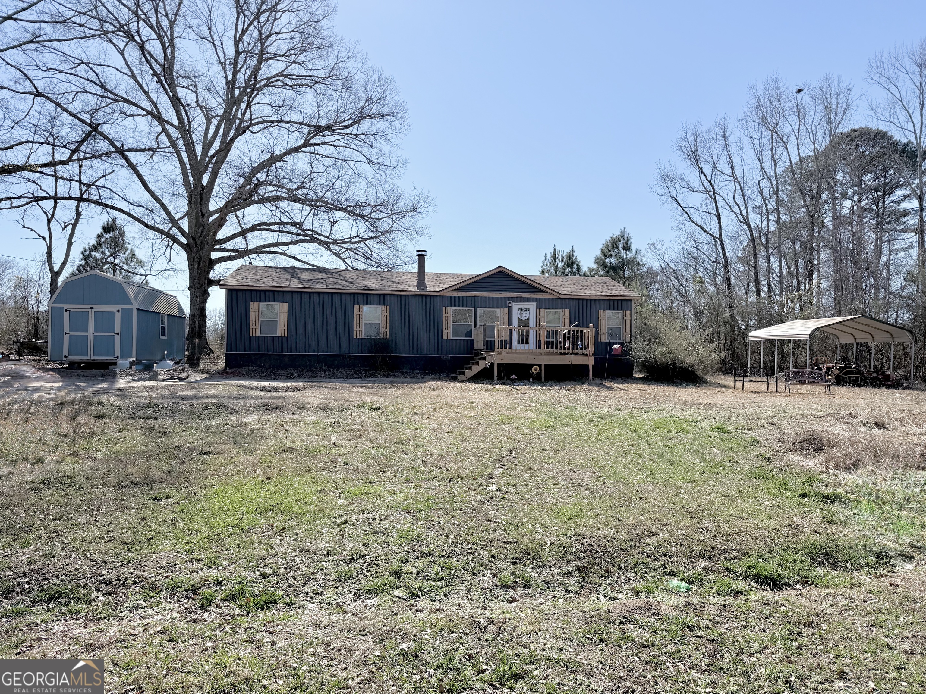 5448 Blanton Mill Road Williamson, GA 30292 - Photo 2 of 50 a view of a house with a yard covered in snow