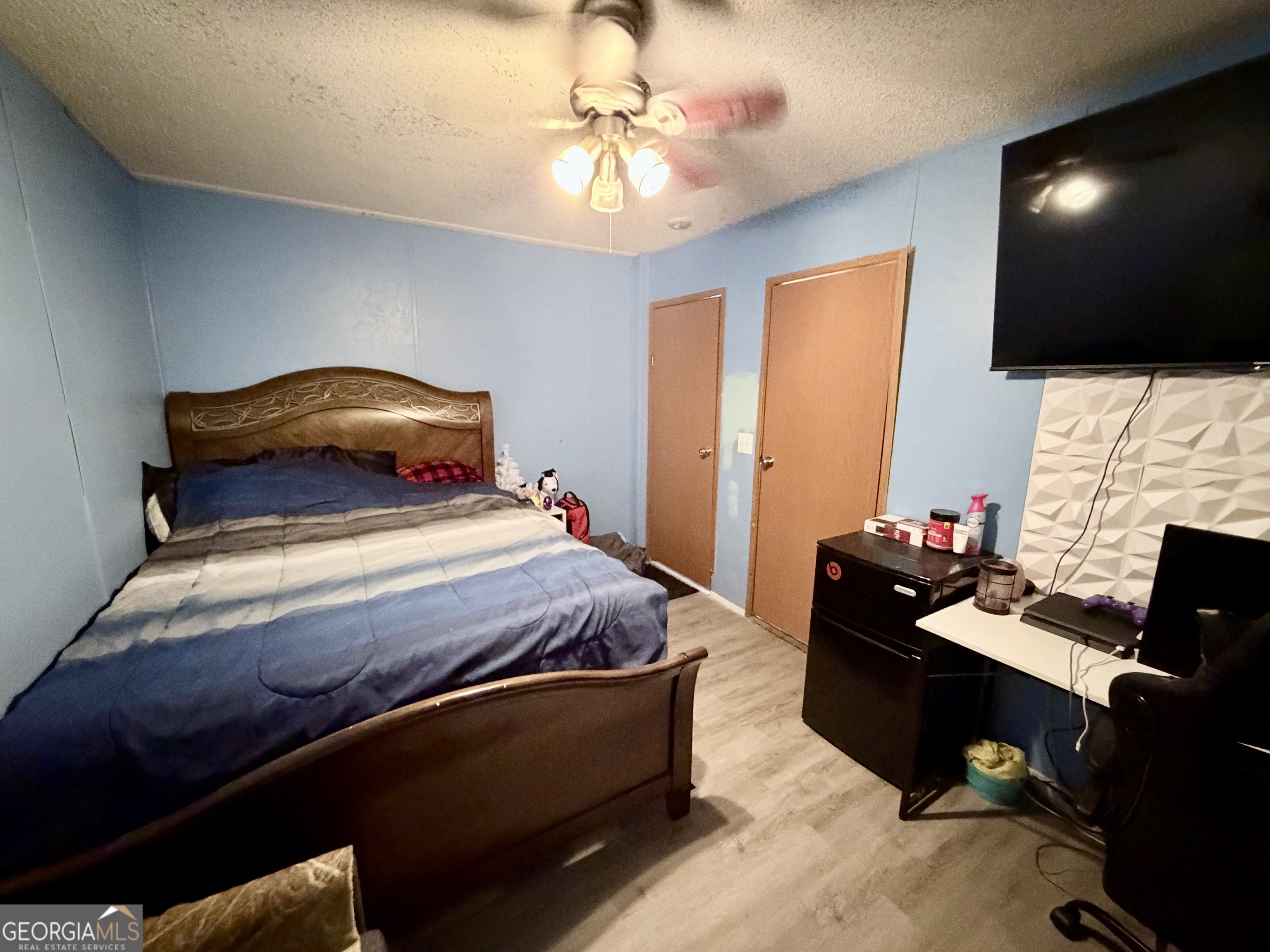 5448 Blanton Mill Road Williamson, GA 30292 - Photo 27 of 50 a bedroom with a bed and a flat screen tv