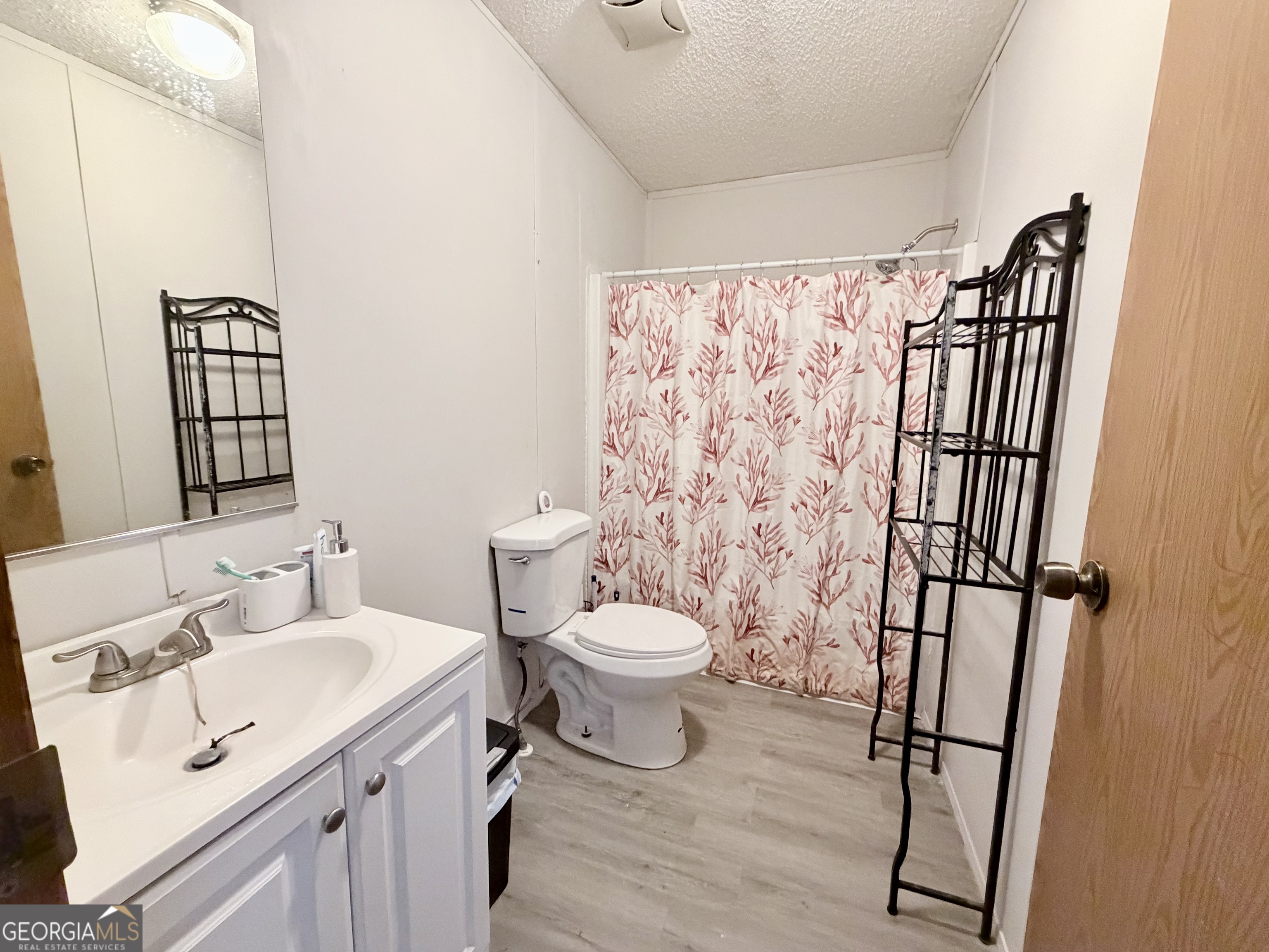 5448 Blanton Mill Road Williamson, GA 30292 - Photo 30 of 50 a bathroom with a sink toilet and shower