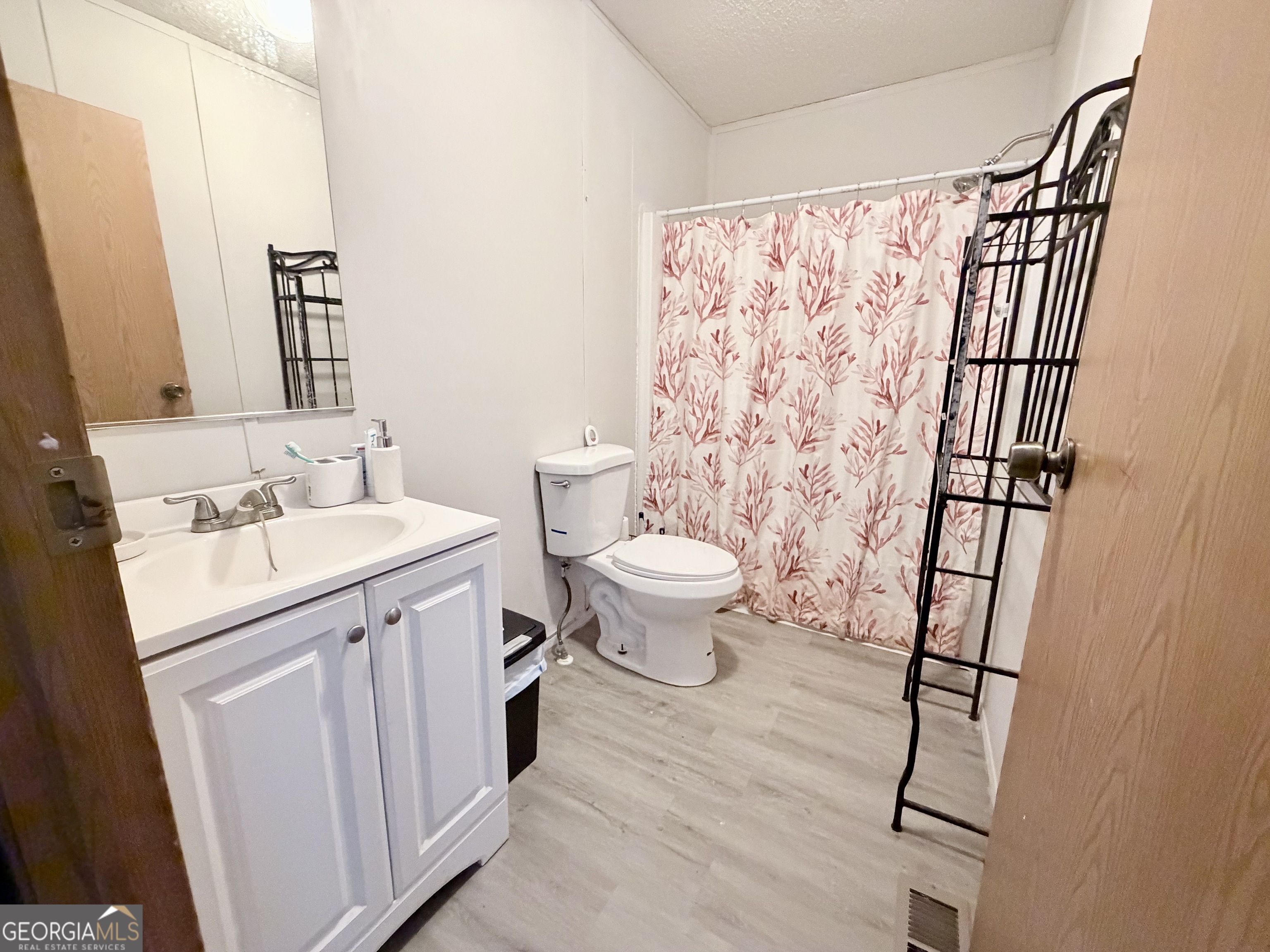 5448 Blanton Mill Road Williamson, GA 30292 - Photo 31 of 50 a bathroom with a sink toilet and shower