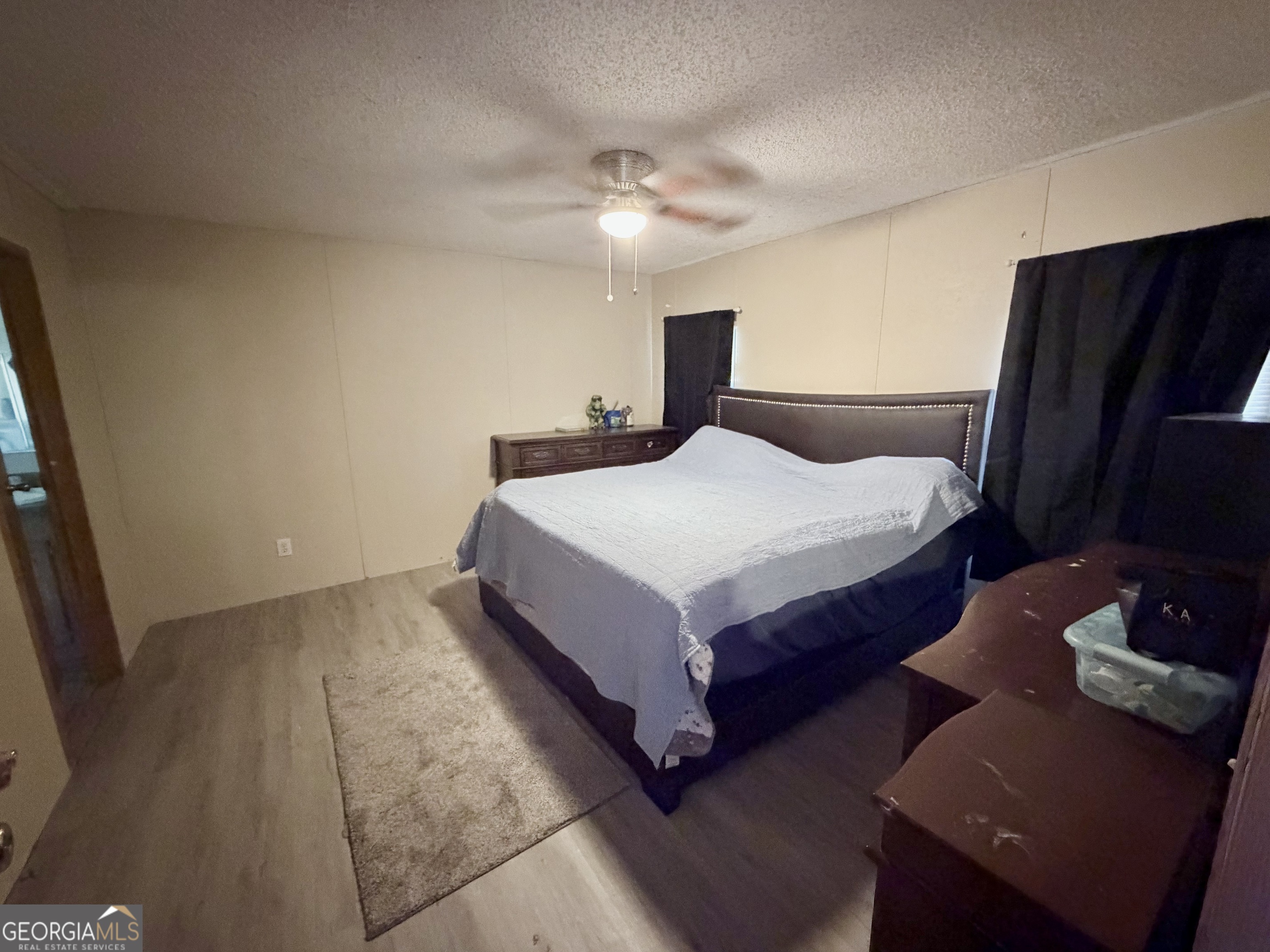 5448 Blanton Mill Road Williamson, GA 30292 - Photo 32 of 50 a spacious bedroom with a bed and a dresser