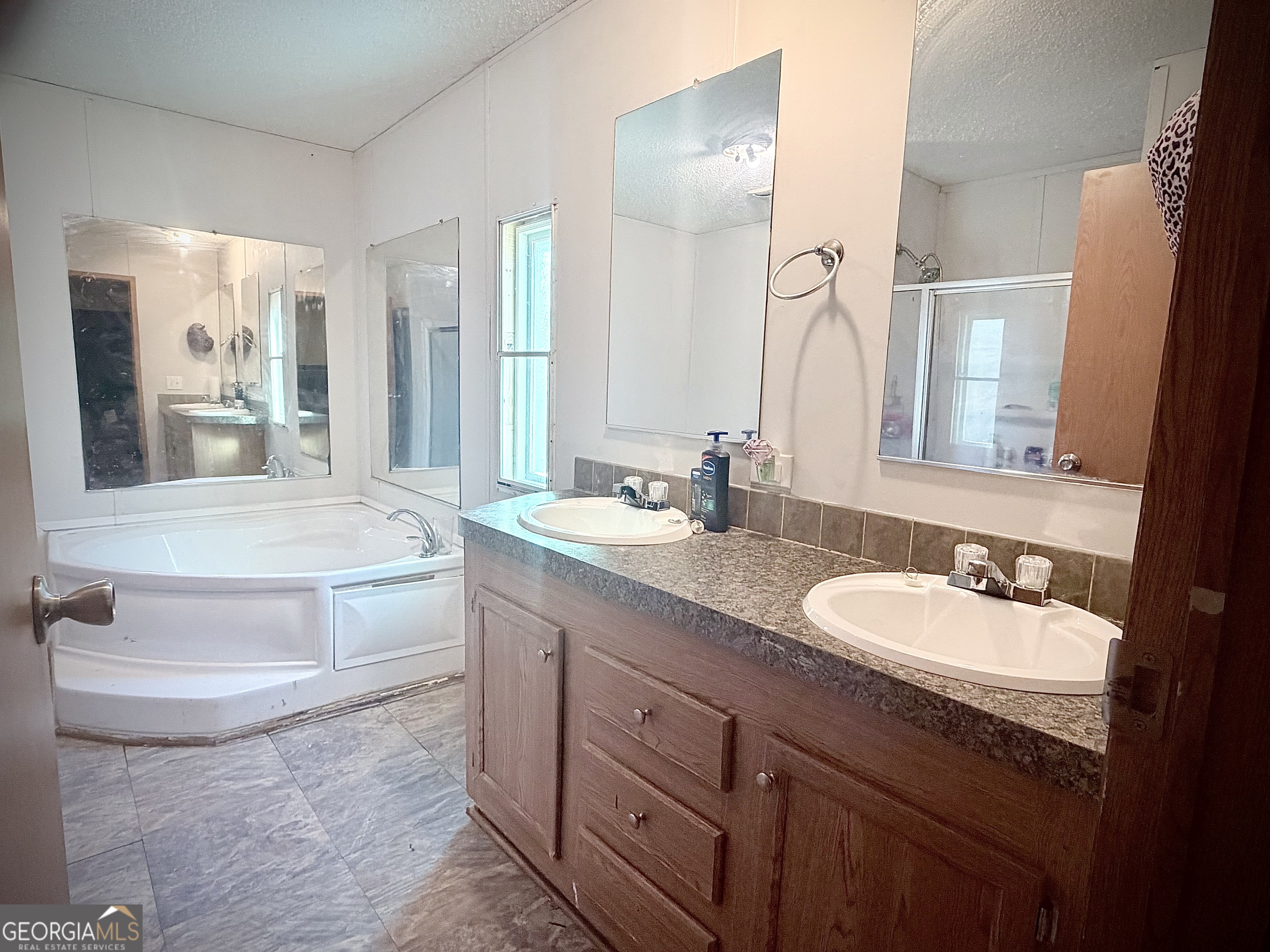 5448 Blanton Mill Road Williamson, GA 30292 - Photo 35 of 50 a bathroom with a double vanity sink and mirror