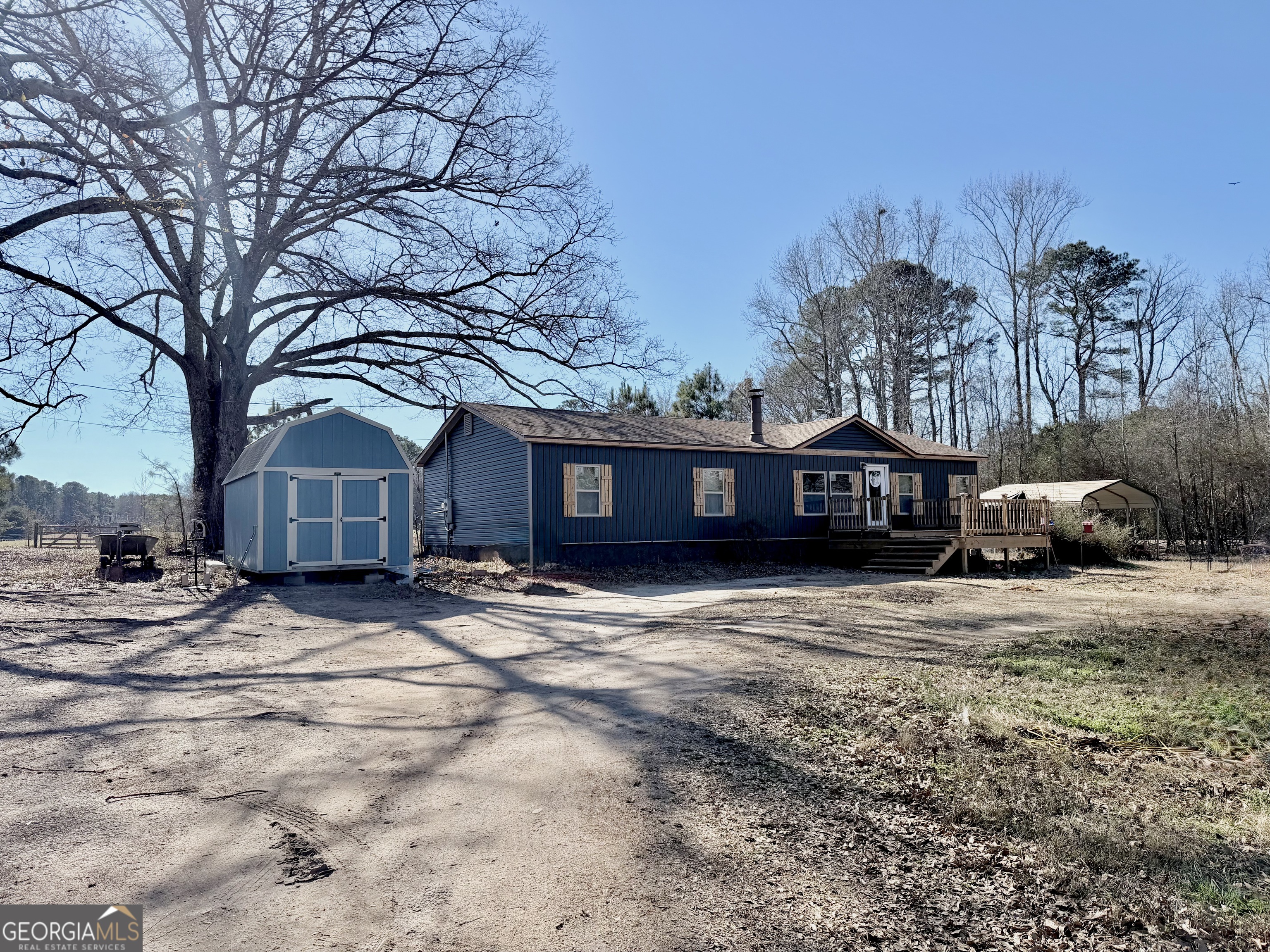5448 Blanton Mill Road Williamson, GA 30292 - Photo 42 of 50 a view of a house with a yard covered in snow
