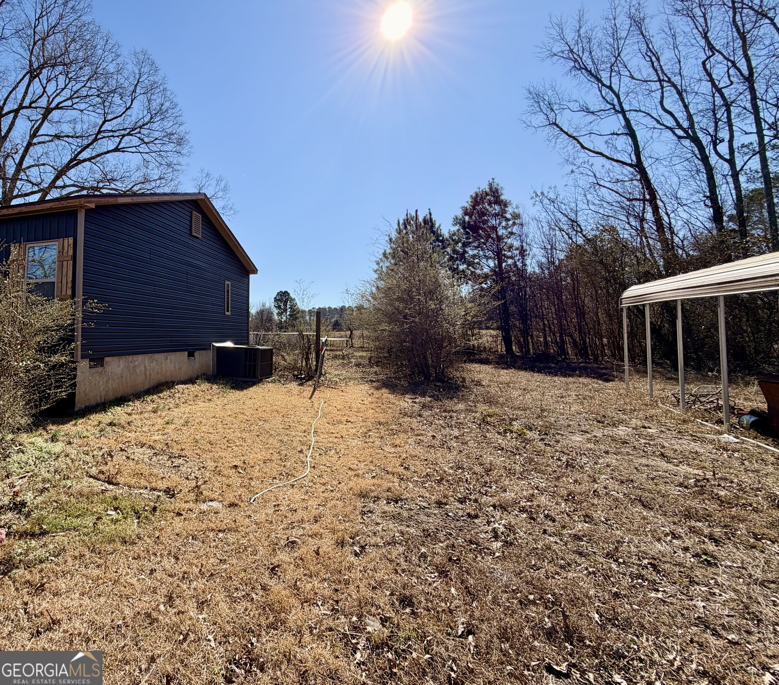 5448 Blanton Mill Road Williamson, GA 30292 - Photo 46 of 50 a backyard of a house with large trees and covered with wooden fence