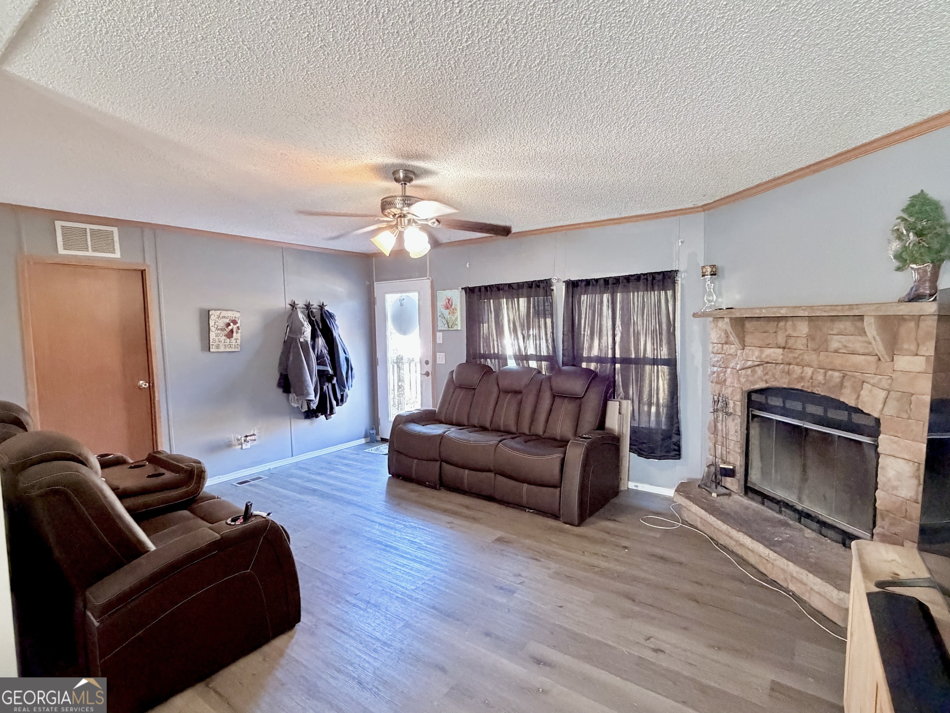 5448 Blanton Mill Road Williamson, GA 30292 - Photo 8 of 50 a living room with furniture and a fireplace