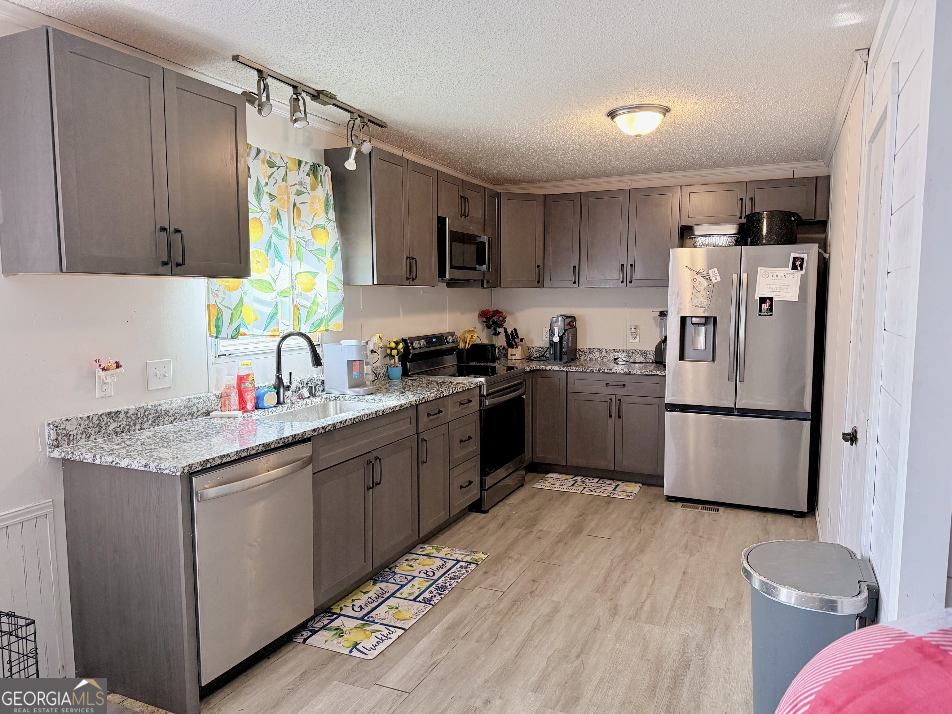 5448 Blanton Mill Road Williamson, GA 30292 - Photo 9 of 50 a kitchen with a sink a refrigerator a stove and wooden cabinets