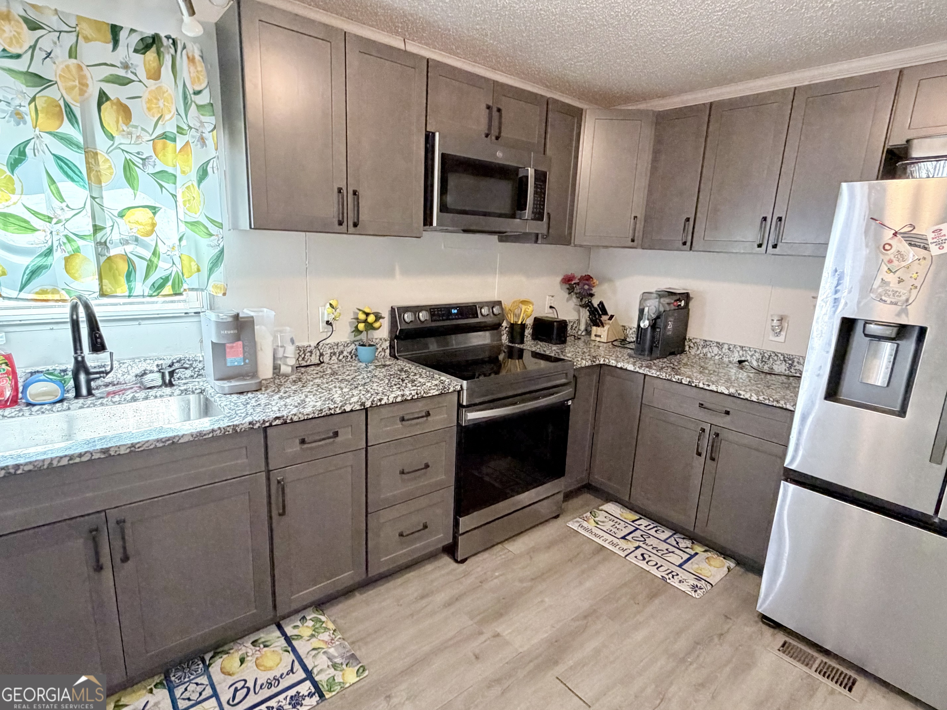 5448 Blanton Mill Road Williamson, GA 30292 - Photo 10 of 50 a kitchen with a sink stove and refrigerator