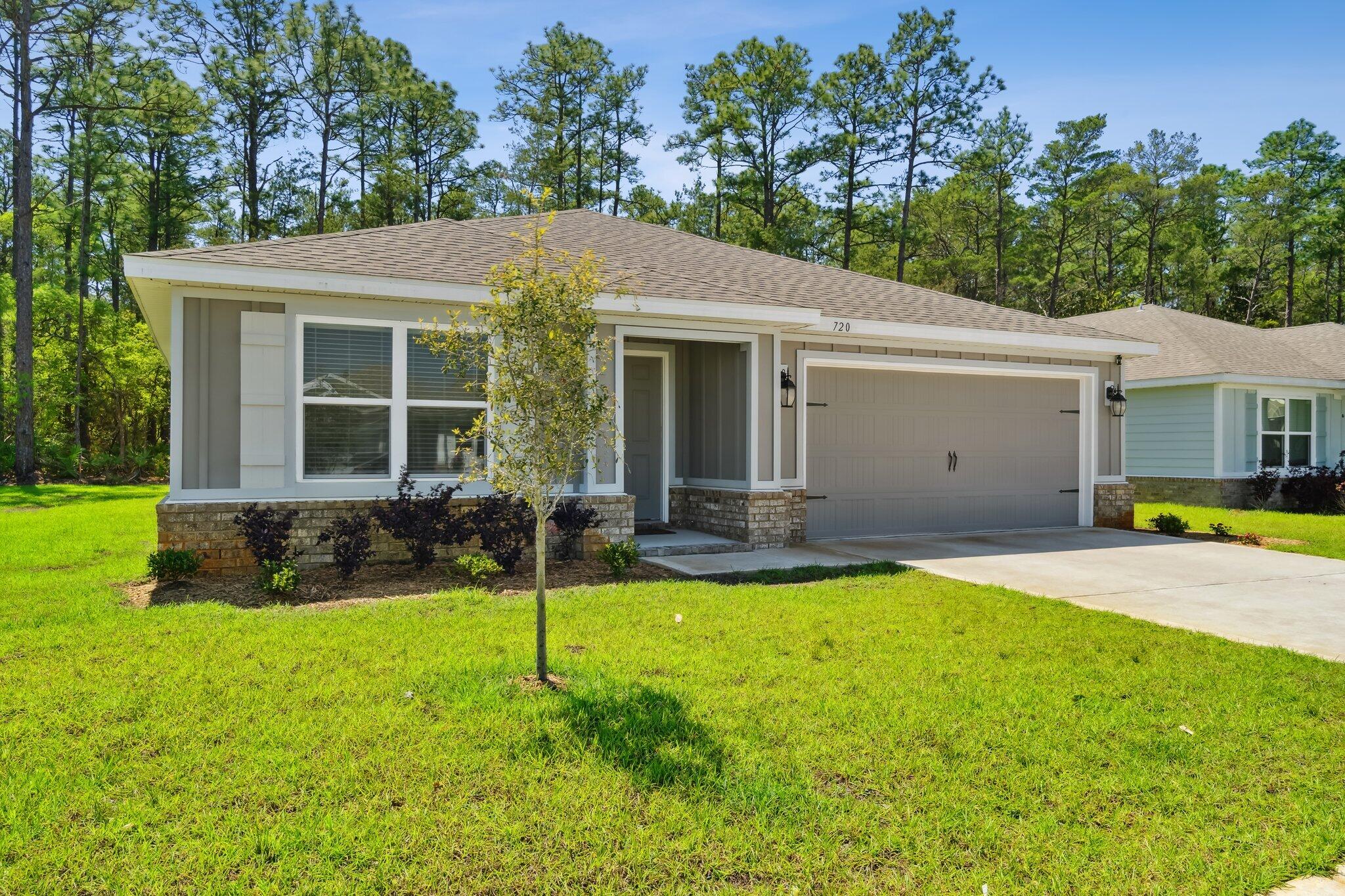 720 Riverwalk Circle Freeport, FL 32439 - Photo 2 of 34 a view of a house with a yard and sitting area