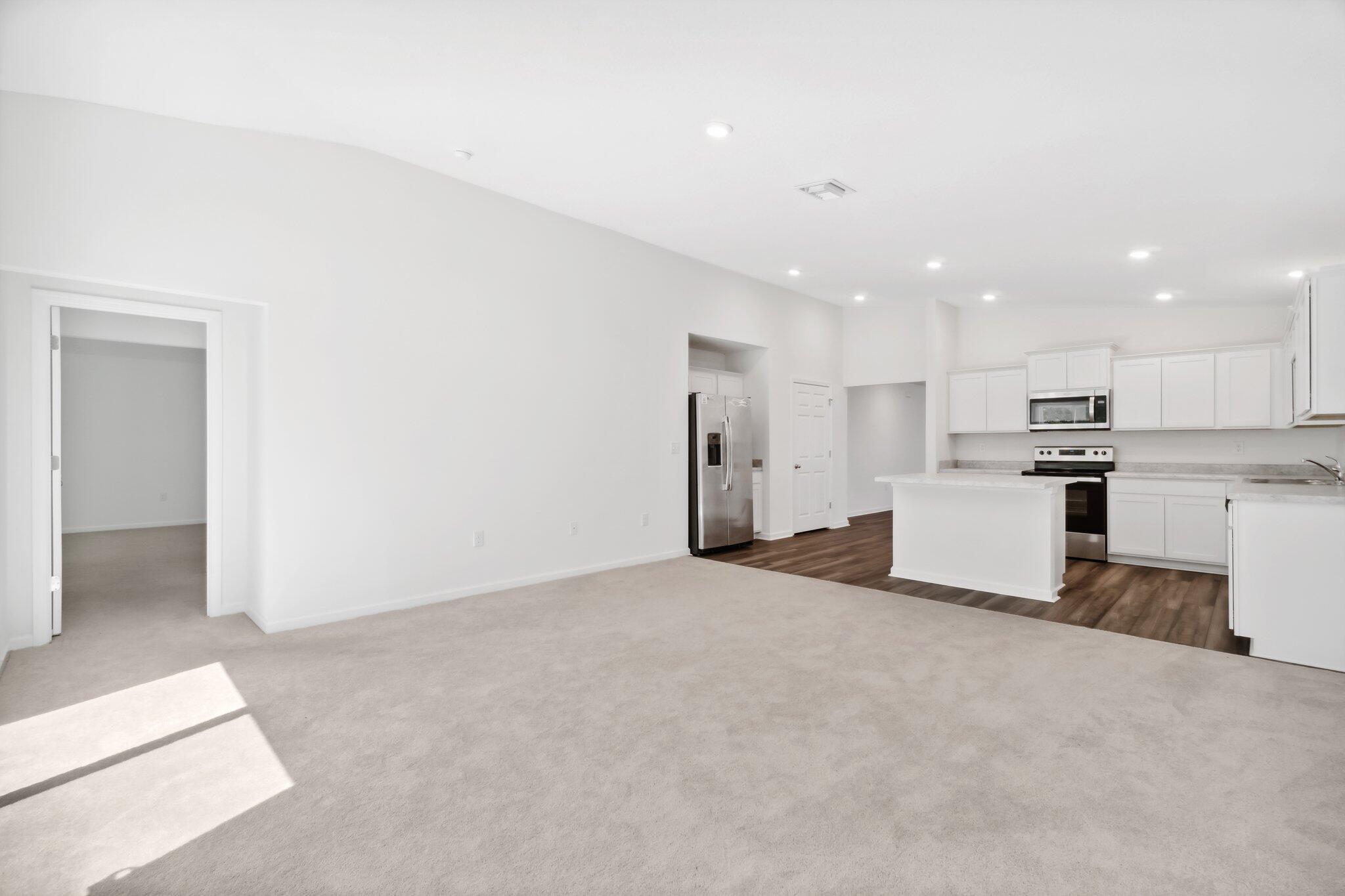 720 Riverwalk Circle Freeport, FL 32439 - Photo 21 of 34 a view of kitchen with refrigerator and white cabinets