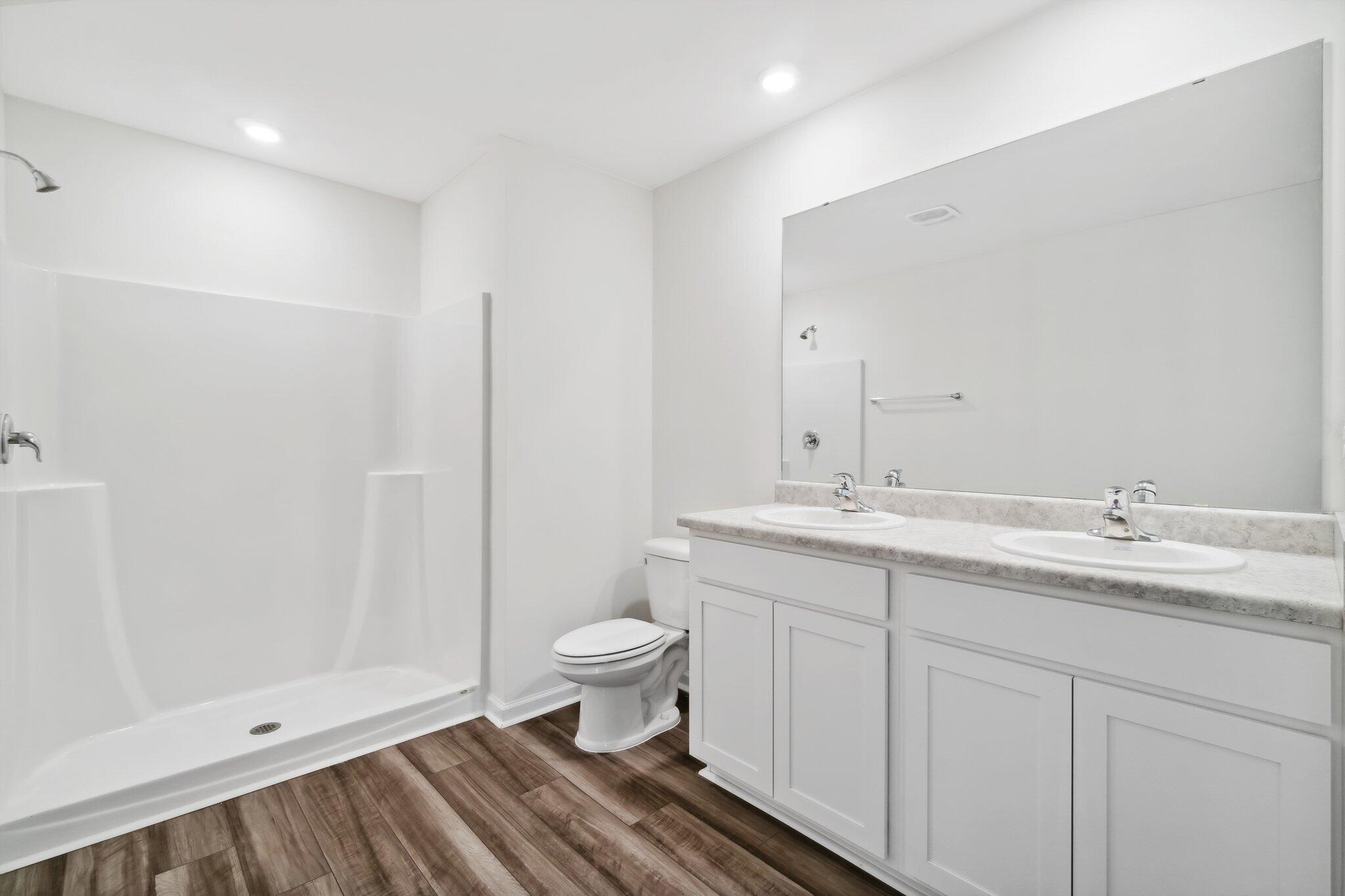 720 Riverwalk Circle Freeport, FL 32439 - Photo 26 of 34 a bathroom with a toilet sink and mirror