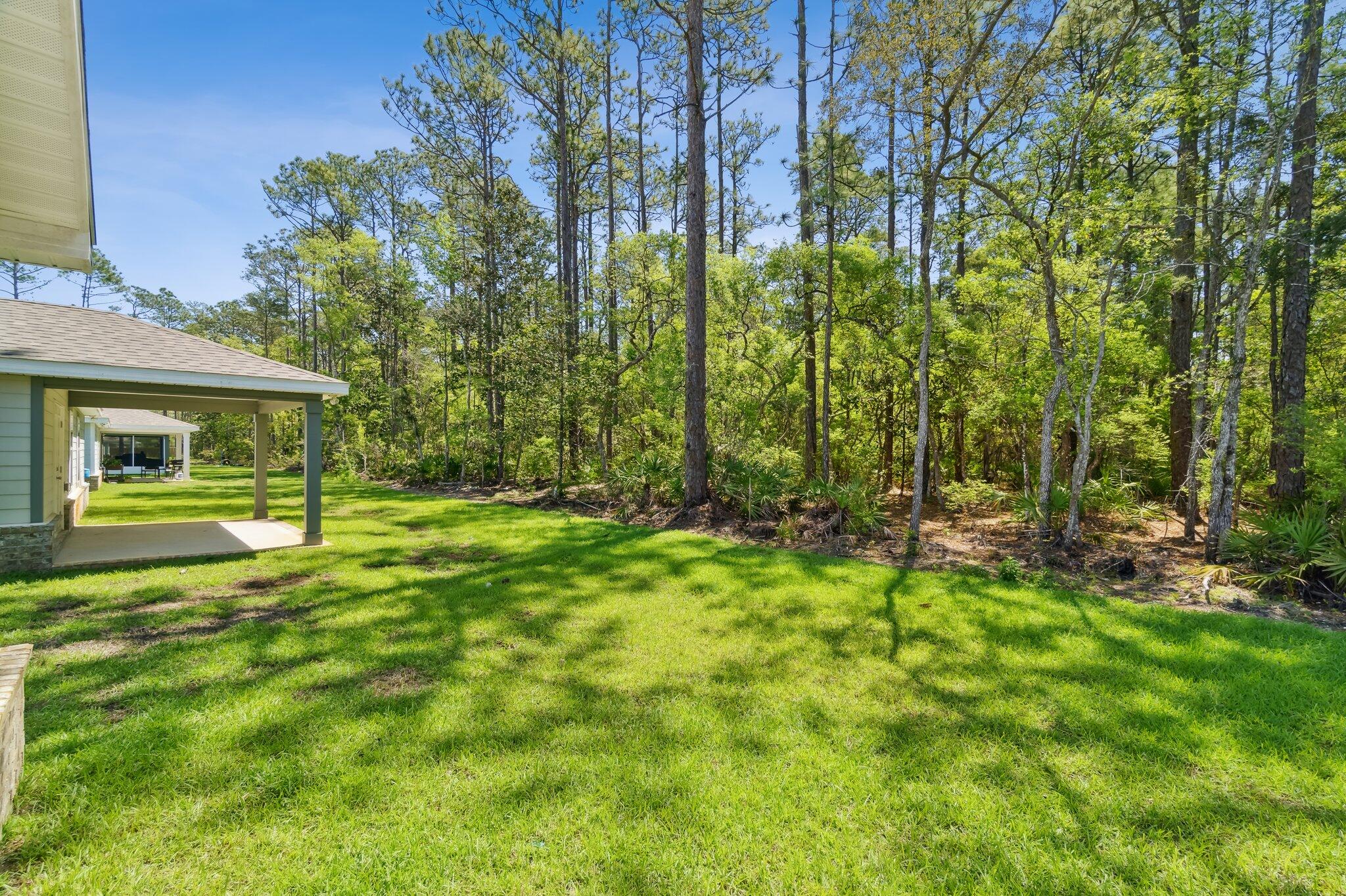 720 Riverwalk Circle Freeport, FL 32439 - Photo 27 of 34 a backyard of a house with lots of green space