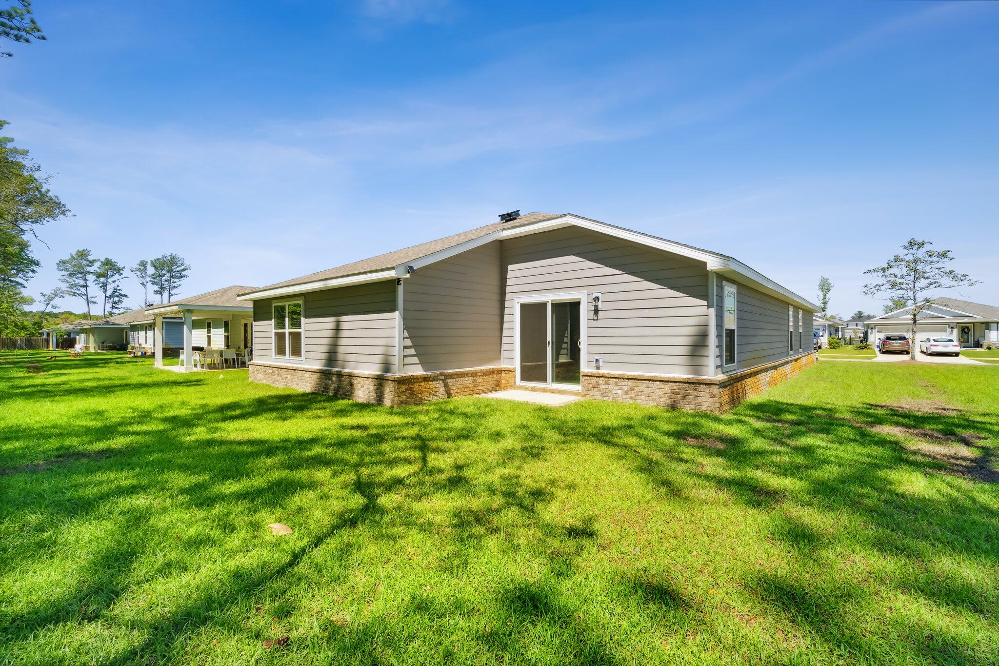 720 Riverwalk Circle Freeport, FL 32439 - Photo 28 of 34 a front view of a house with a yard