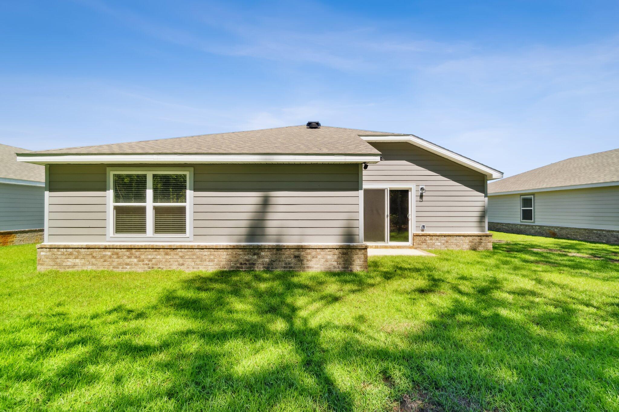 720 Riverwalk Circle Freeport, FL 32439 - Photo 29 of 34 a front view of a house with a yard