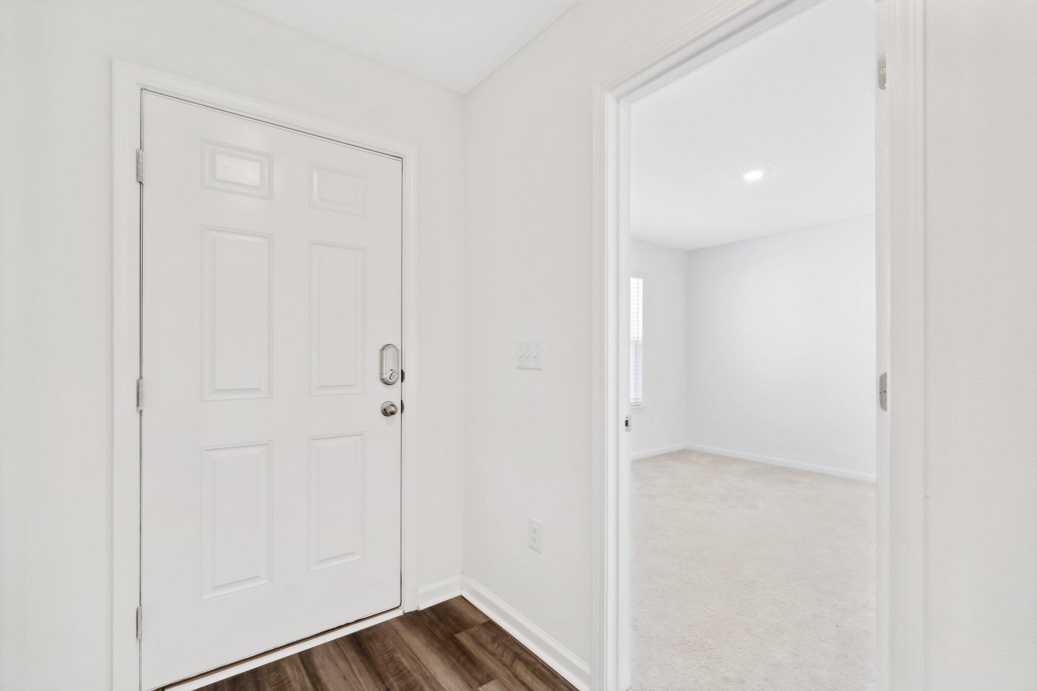 720 Riverwalk Circle Freeport, FL 32439 - Photo 4 of 34 a view of a hallway with wooden floor