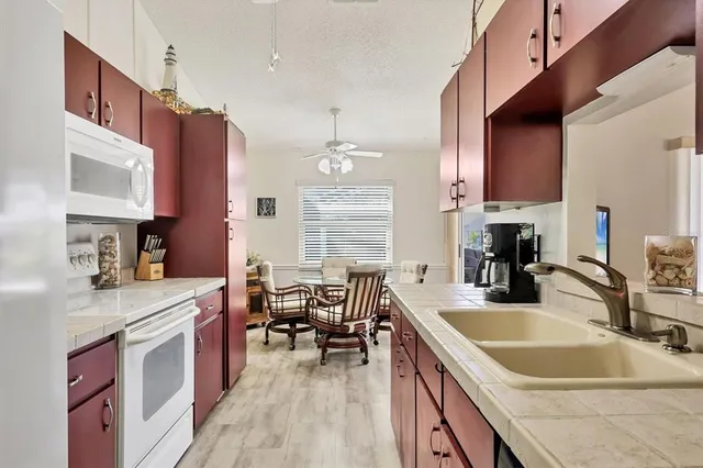 a kitchen with granite countertop a sink stove and cabinets