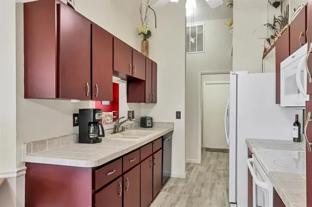 a kitchen with a sink stove and cabinets