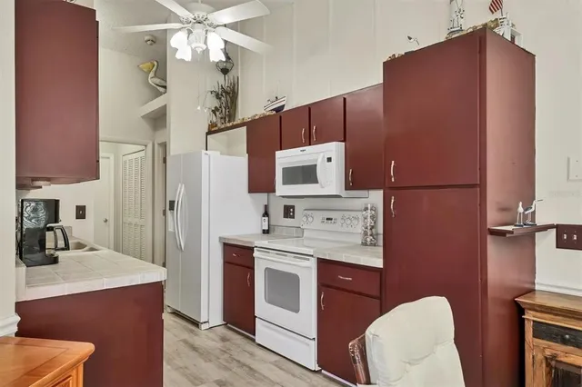 a kitchen with stainless steel appliances a microwave a stove and a refrigerator