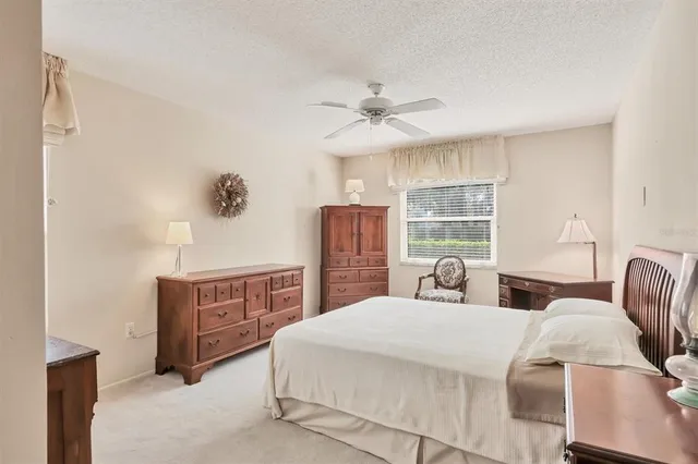 a bedroom with a large bed and wooden floor