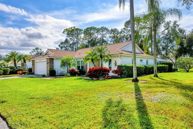 a view of a house with a backyard and a patio