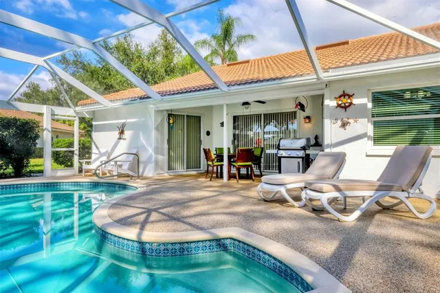 a view of a house with backyard porch and sitting area