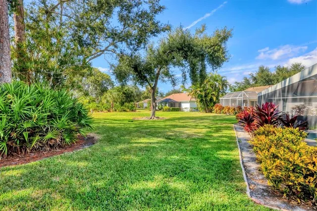 a view of a garden with flowers and trees