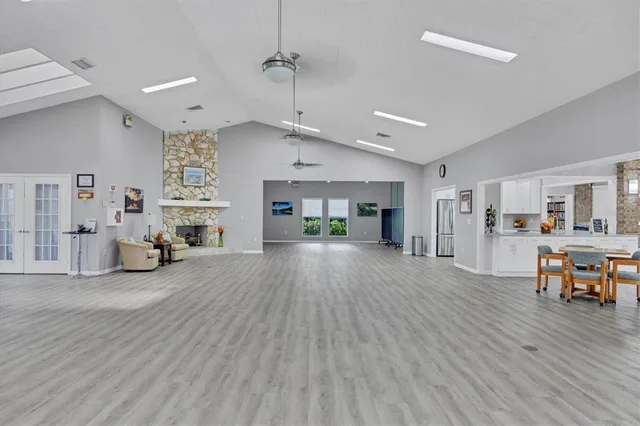 a view of a dining hall with a dining table and chairs with wooden floor