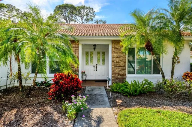 a front view of a house with a garden