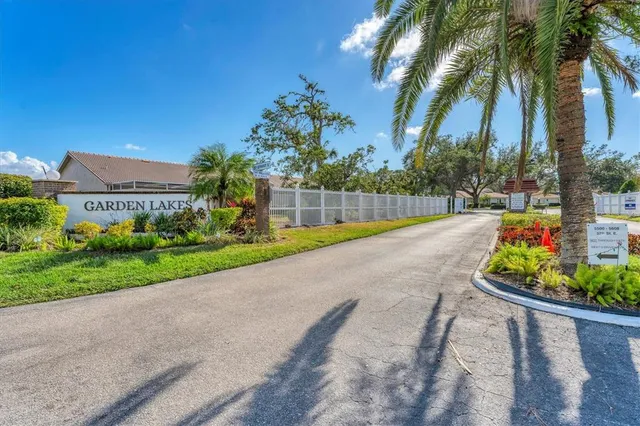 a sign that is in front of flowers