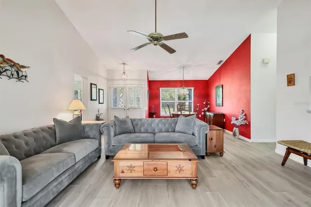 a living room with furniture and a wooden floor