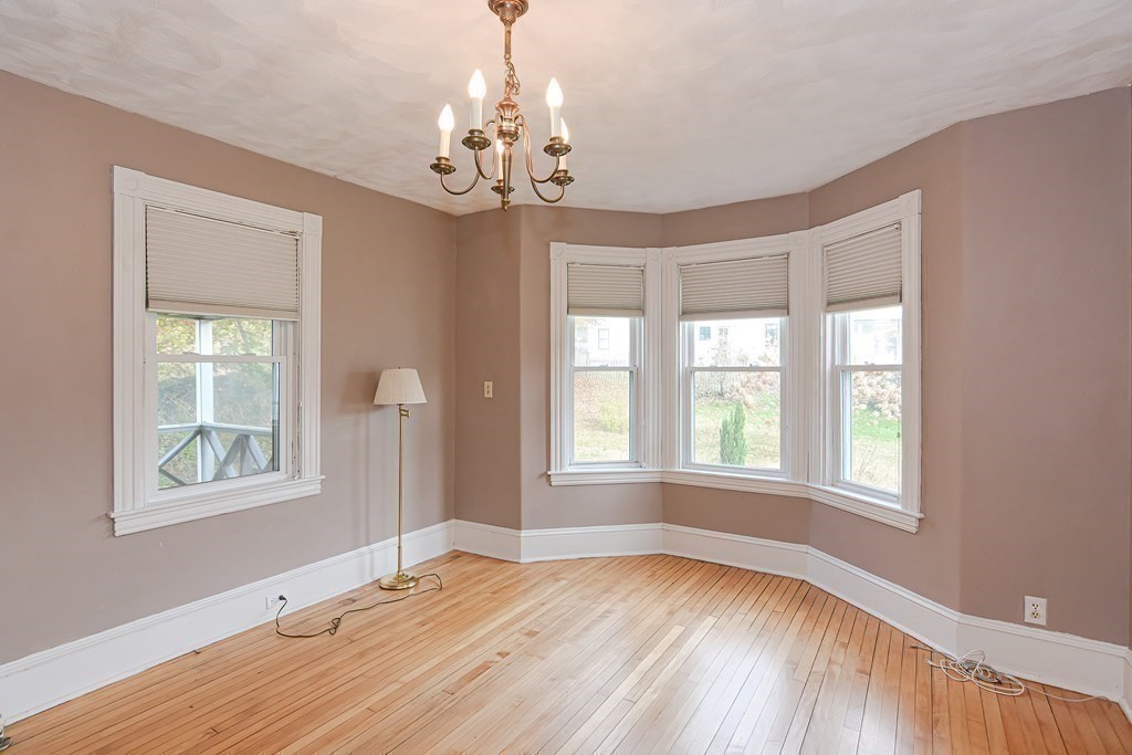 83 Eliot Street Natick, MA 01760 - Photo 19 of 42 a view of an empty room with wooden floor and a window