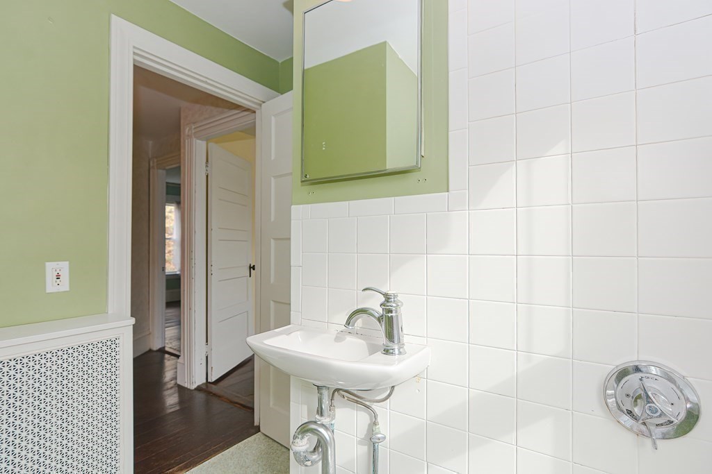83 Eliot Street Natick, MA 01760 - Photo 25 of 42 a bathroom with a sink and a mirror