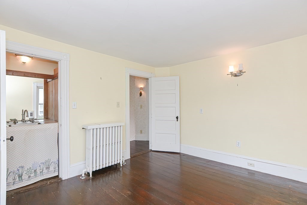 83 Eliot Street Natick, MA 01760 - Photo 27 of 42 wooden floor in a hall with a window