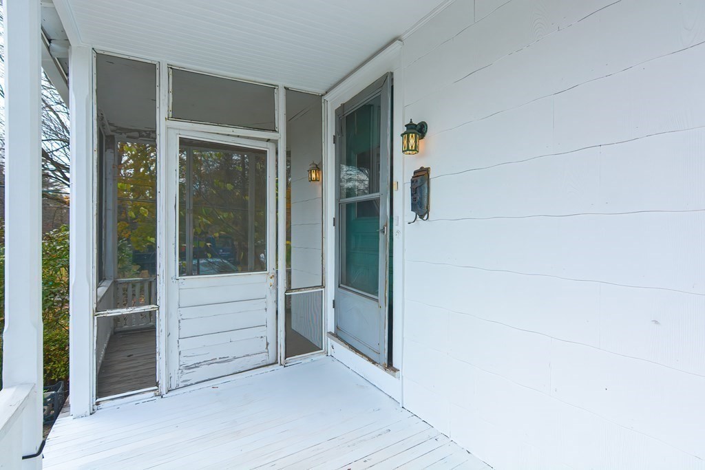 83 Eliot Street Natick, MA 01760 - Photo 5 of 42 an empty room with sliding door and wooden floor