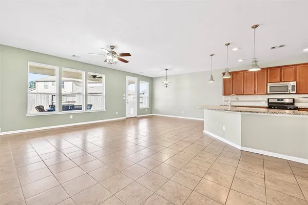a view of a kitchen with microwave and windows