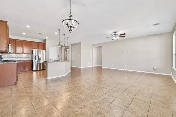 a view of a kitchen with furniture and stainless steel appliances