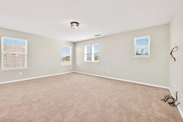 an empty room with windows and closet