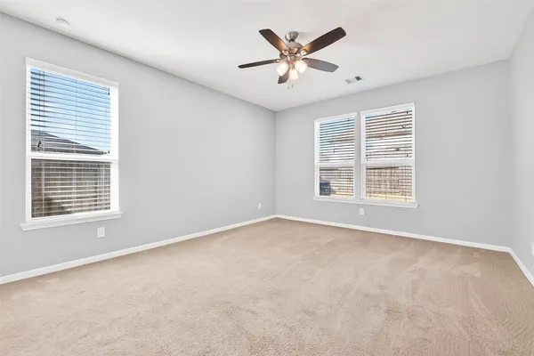 an empty room with a empty space and windows