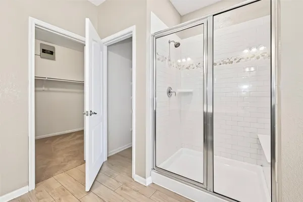 a bathroom with a glass shower door