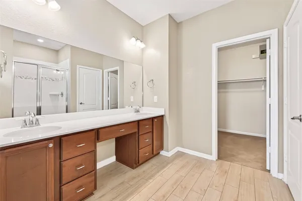 a bathroom with a double vanity sink and a mirror
