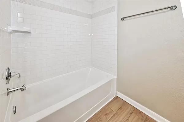 a bathroom with a bathtub and a shower