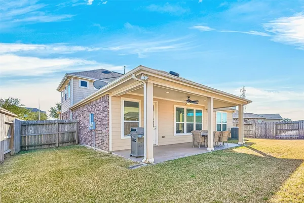 a view of a house with wooden fence