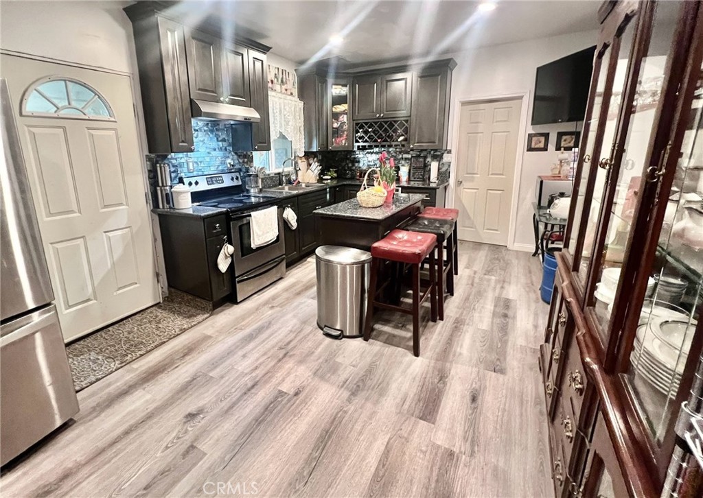 1166 El Mirage Road Adelanto, CA 92301 - Photo 11 of 21 a room with lots of wooden furniture and wooden floor