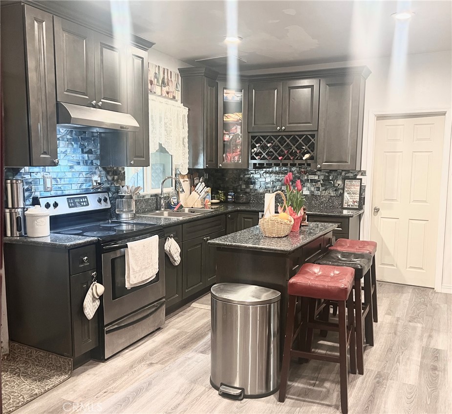 1166 El Mirage Road Adelanto, CA 92301 - Photo 15 of 21 a kitchen with a stove a sink and a refrigerator