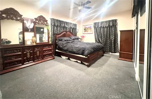 a spacious bedroom with a bed dresser and a window