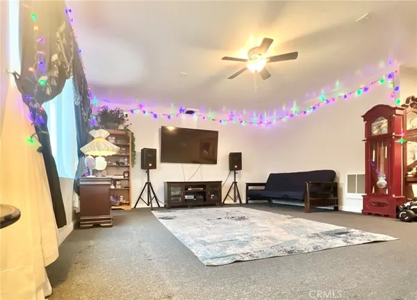 a bedroom with furniture and a flat screen tv