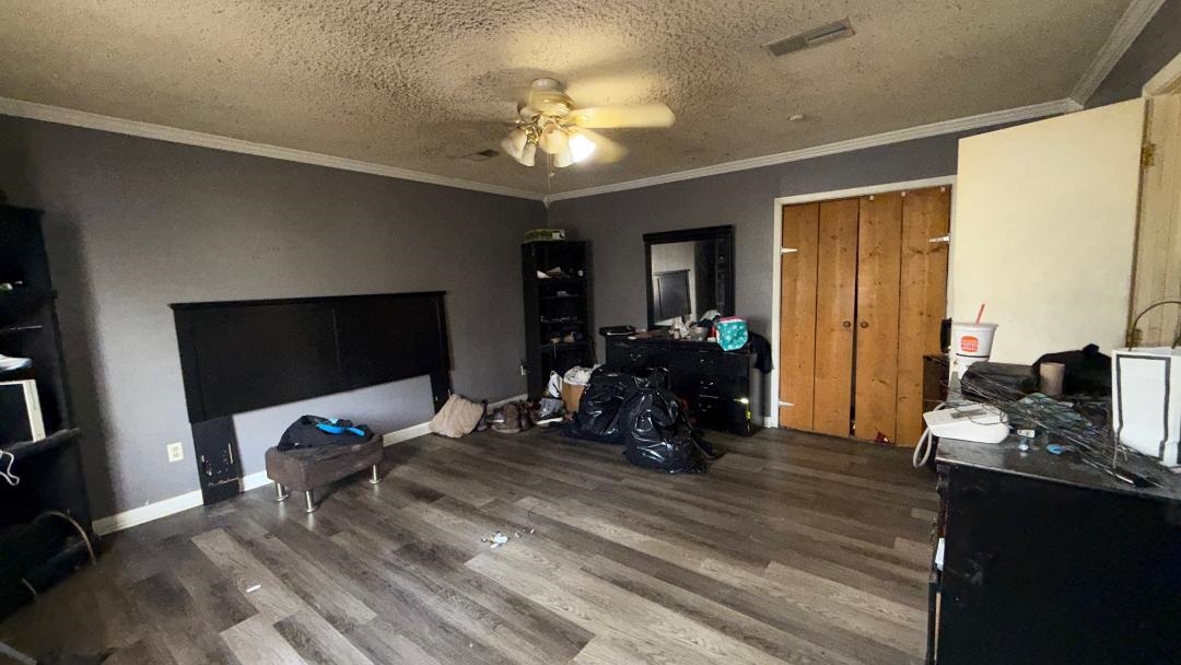 1507 Rich Road West Memphis, AR 72301 - Photo 5 of 12 Bedroom featuring a textured ceiling, wood finished floors, a ceiling fan, and crown molding