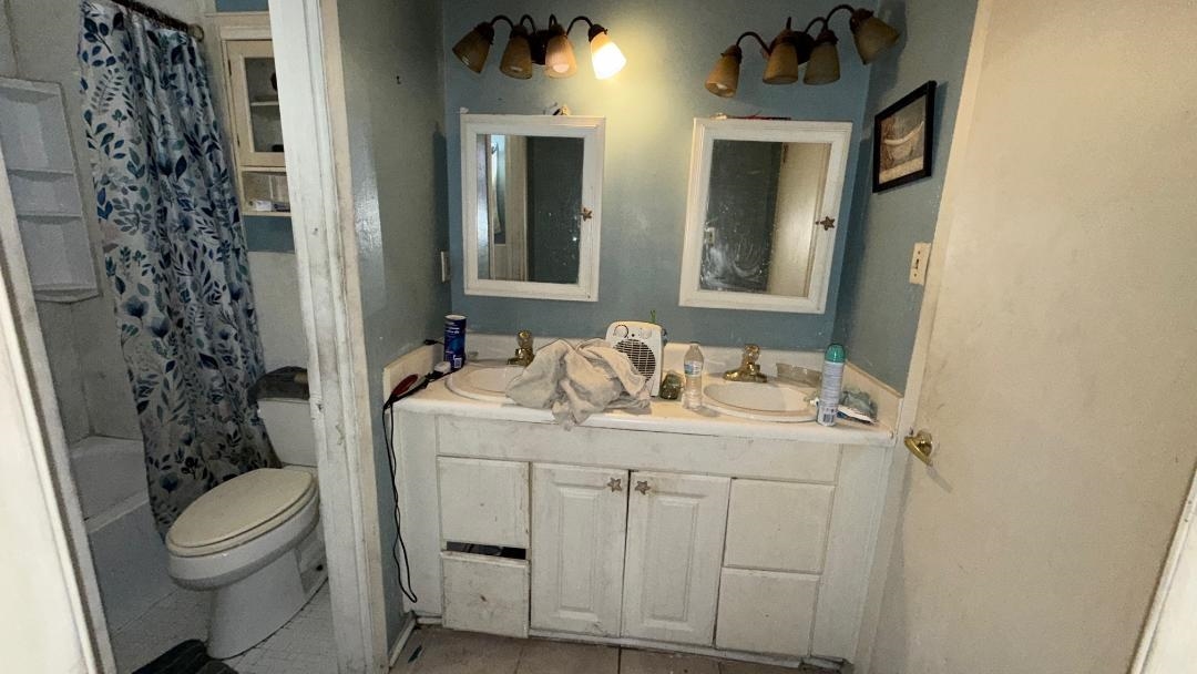 1507 Rich Road West Memphis, AR 72301 - Photo 7 of 12 Bathroom with double vanity, shower / bath combo, and light tile patterned floors